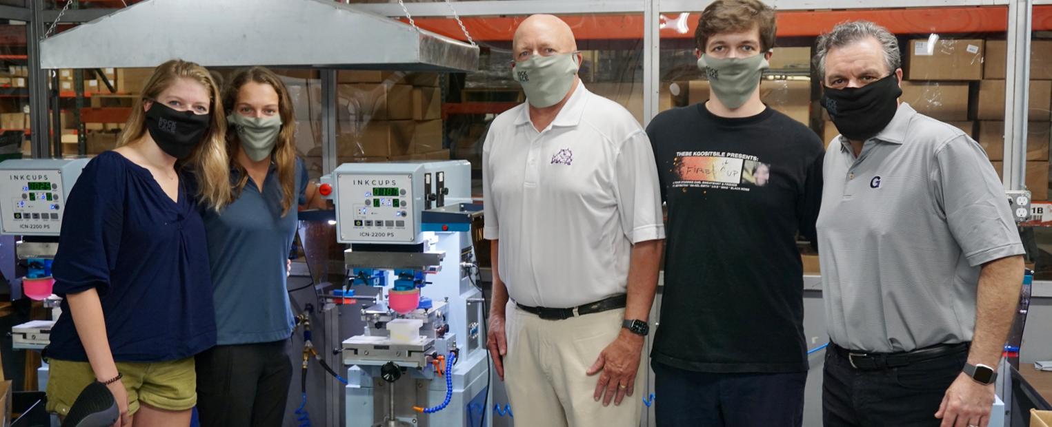 photo of Elizabeth Trexler and family in a production facility