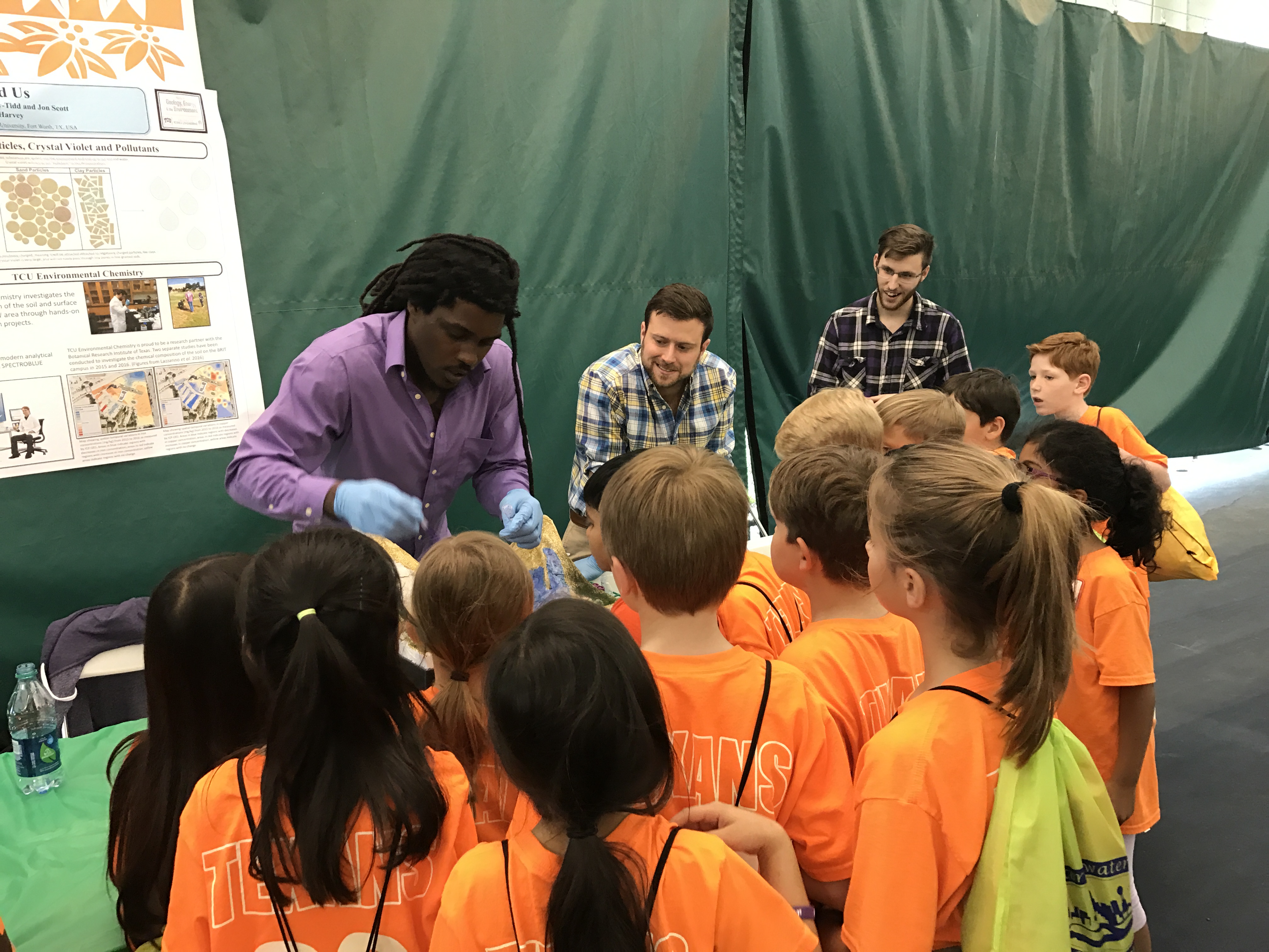 A group of young students gathers for a presentation